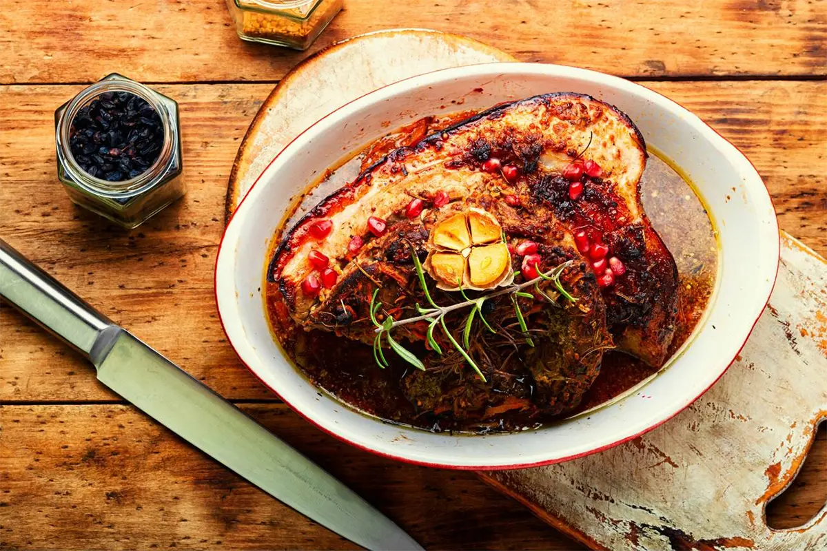 Sliced smoked meatloaf on a serving platter with garnish