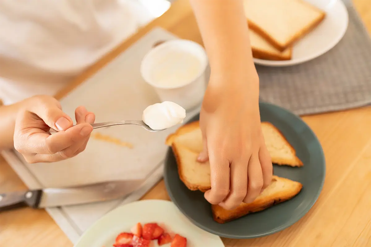 Assorted bread slices for French toast on a wooden cutting board