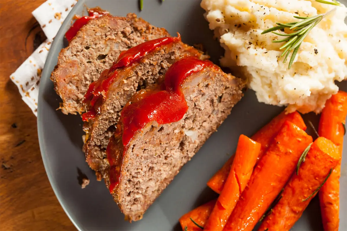 Freshly sliced juicy meatloaf on a serving plate