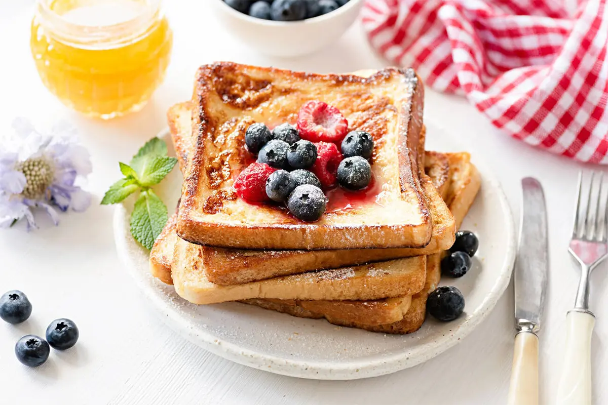 Golden brown French toast served with syrup