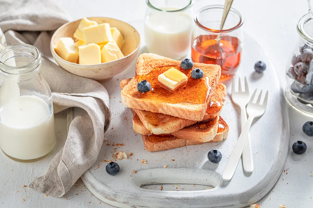 Whisking eggs with milk and cinnamon for French toast