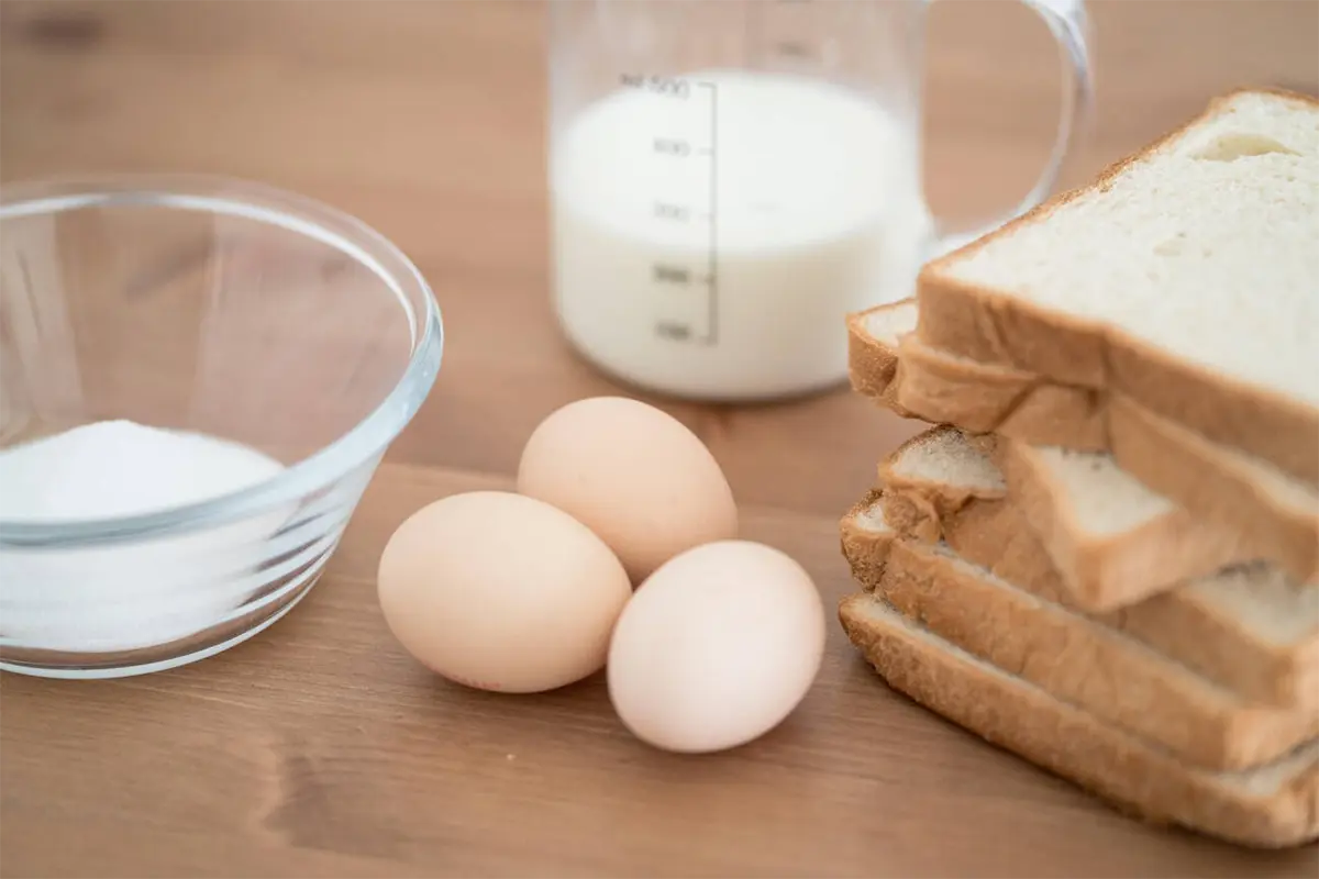 Basic ingredients for making French toast arranged on a kitchen counter