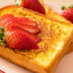 Gourmet French toast served with berries and syrup