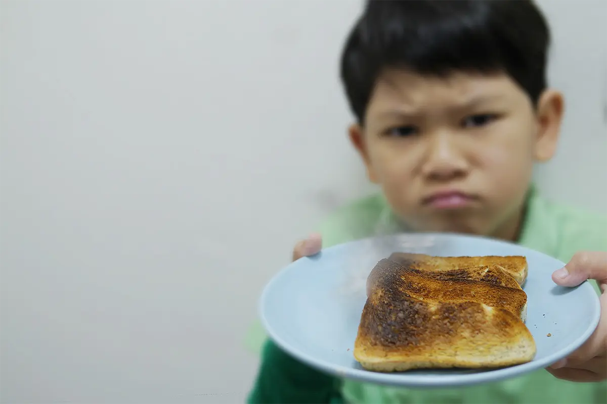 Golden French toast being cooked on a griddle